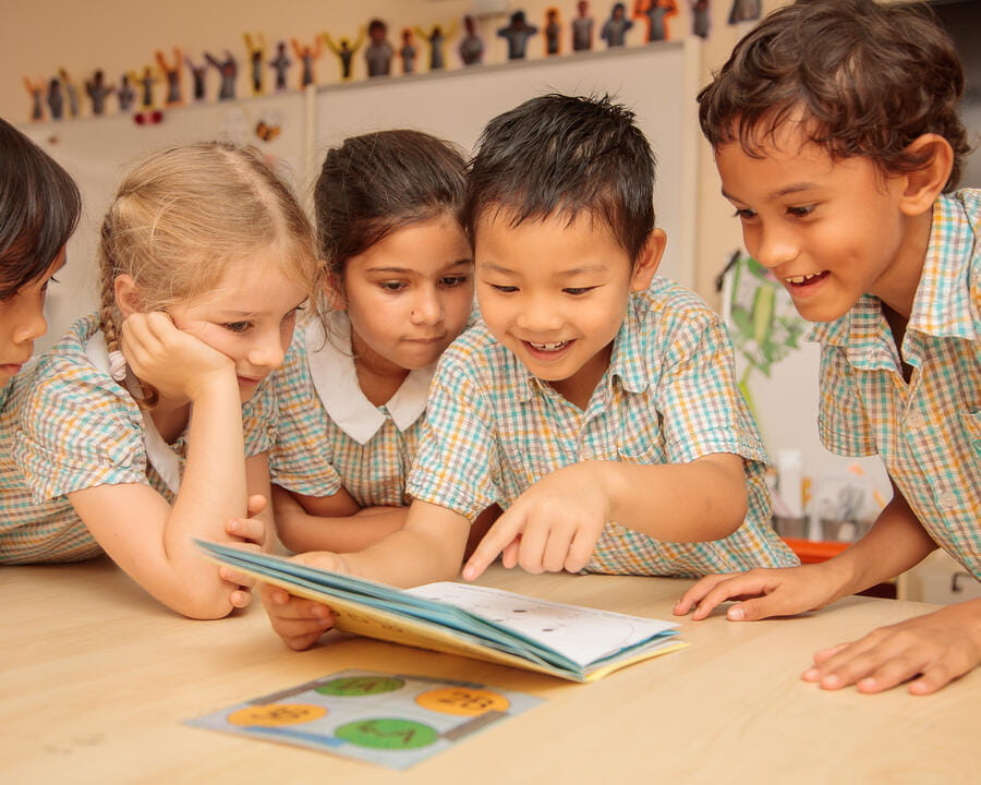 Young students reading and smiling