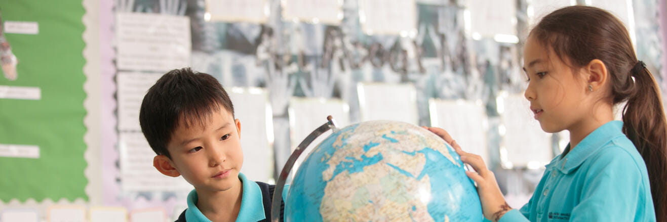 Students looking at a Globe