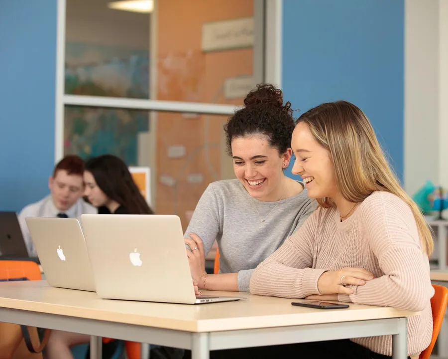 Students studying on Apple Mac laptops