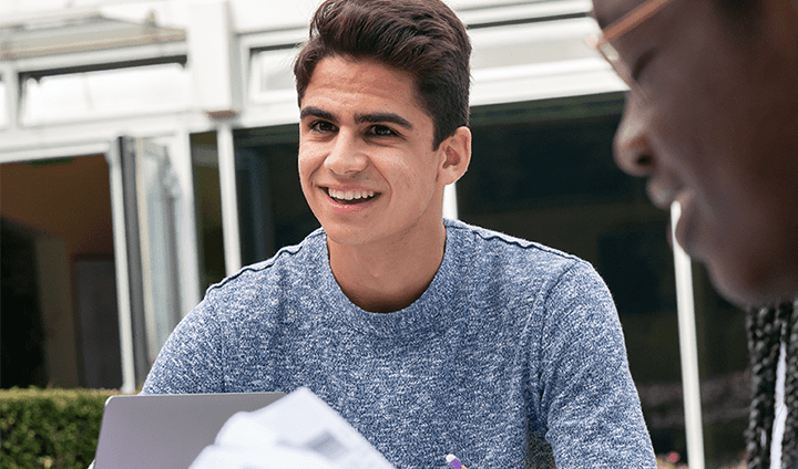 boy in grey top studying