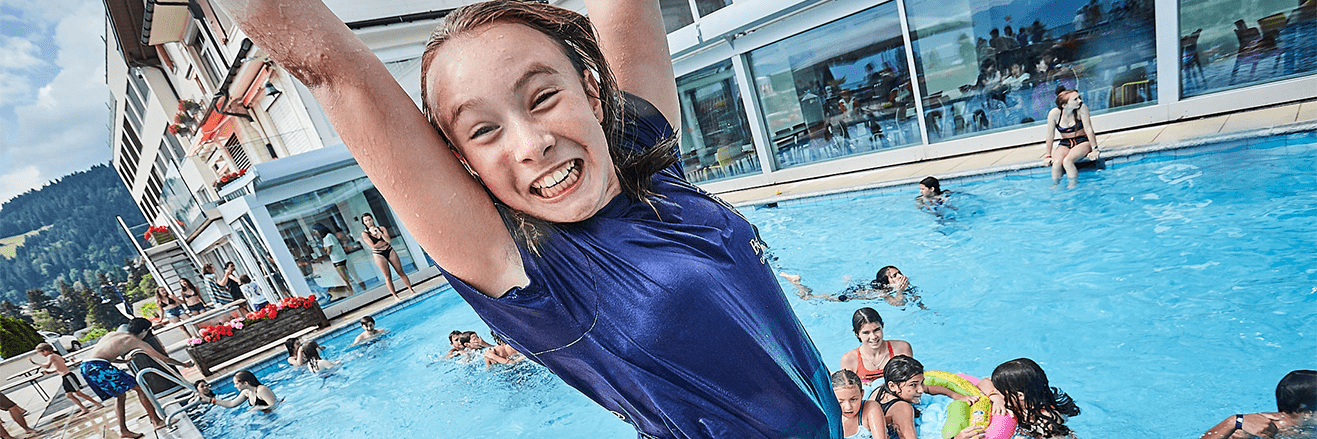 Summer Camps Switzerland | Nord Anglia Education -Tertiary Page Header 1-Student jumping into a pool