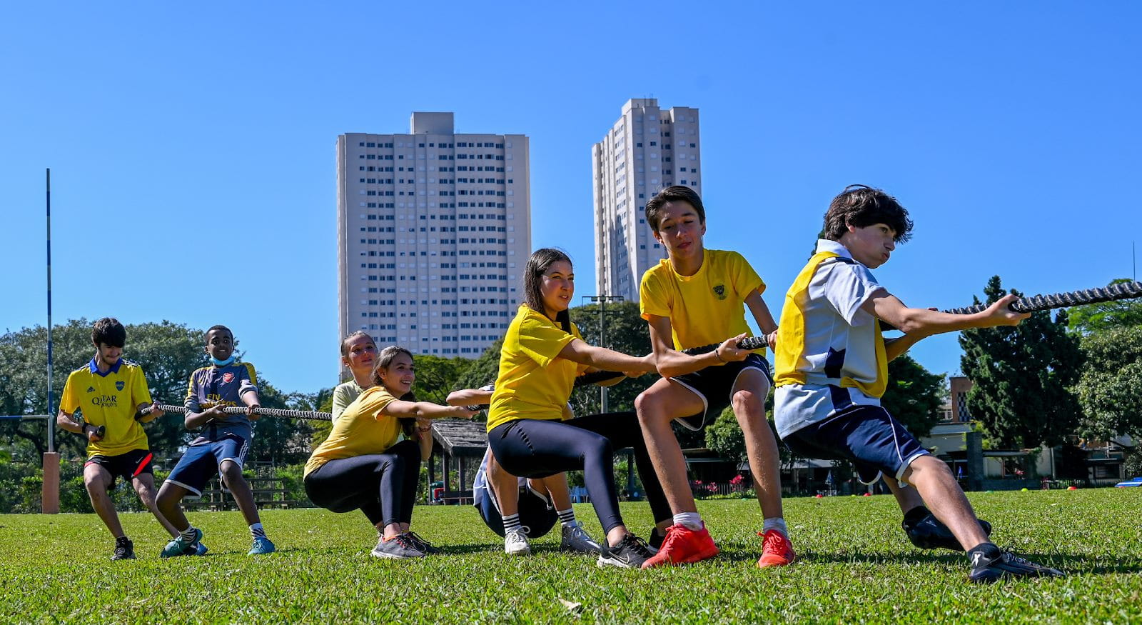 A group of people in a fieldDescription automatically generated with low confidence