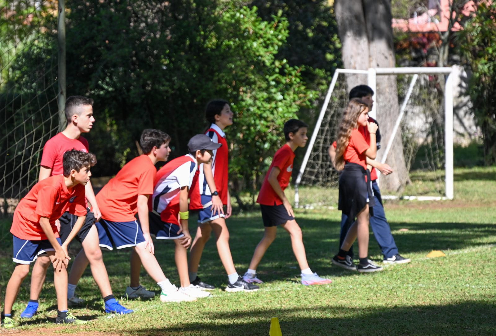 A group of kids playing footballDescription automatically generated with medium confidence