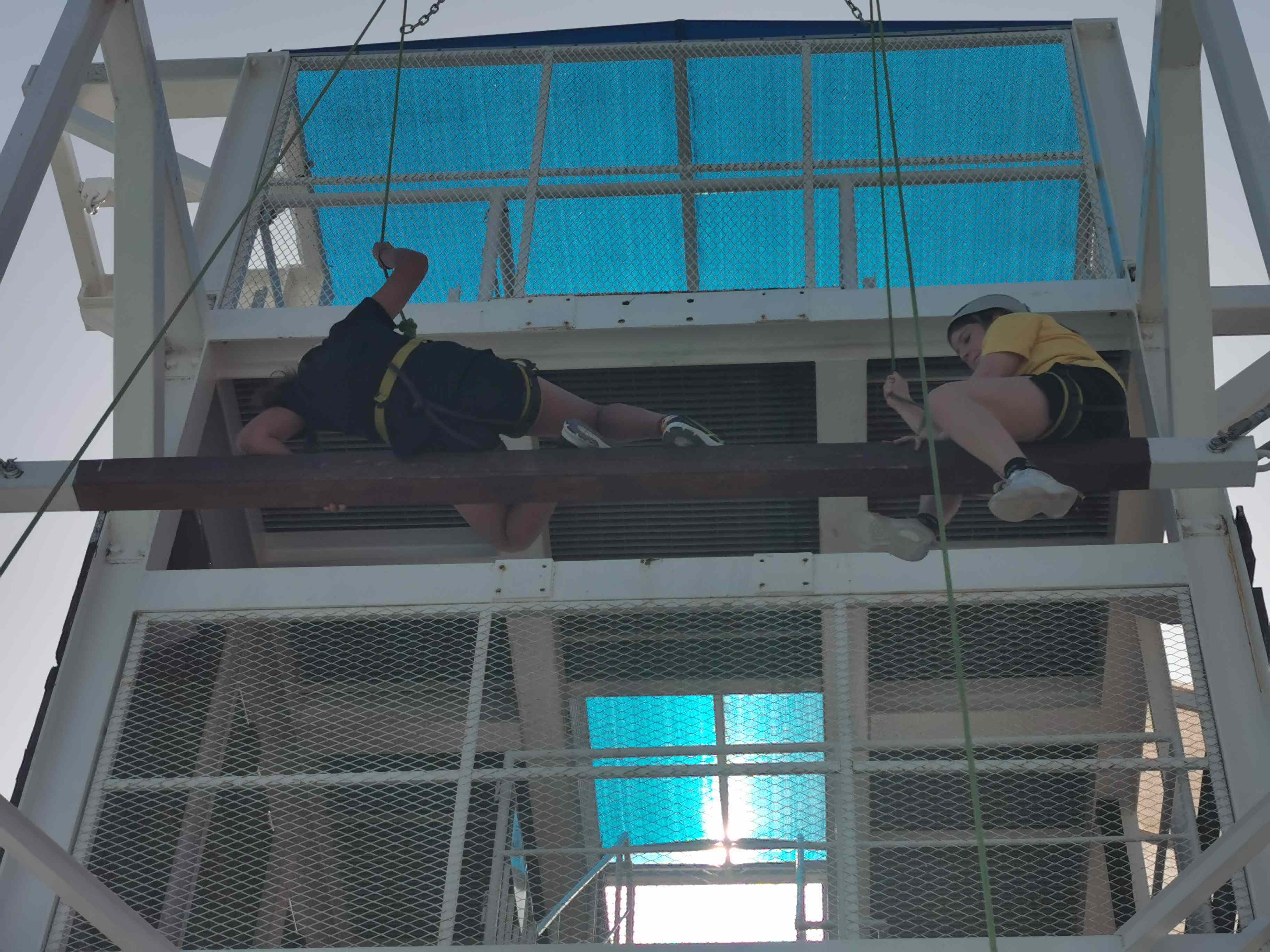 Students climbing a tower in Dibba