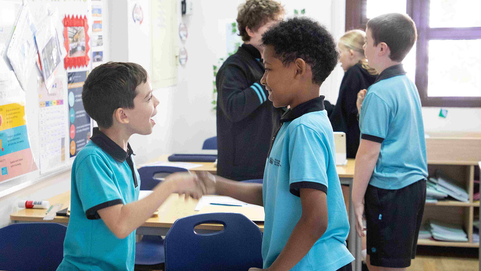 Two students practicing greetings in language class