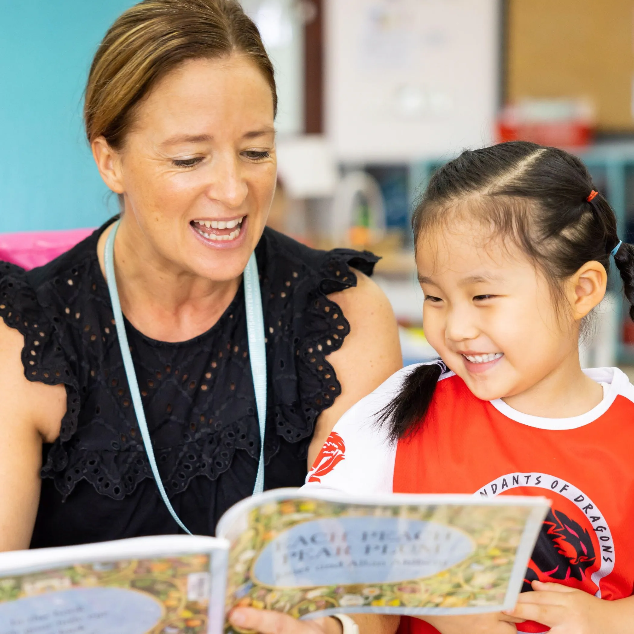 EYFS Student with Teacher Reading EYFS Student with Teacher Reading