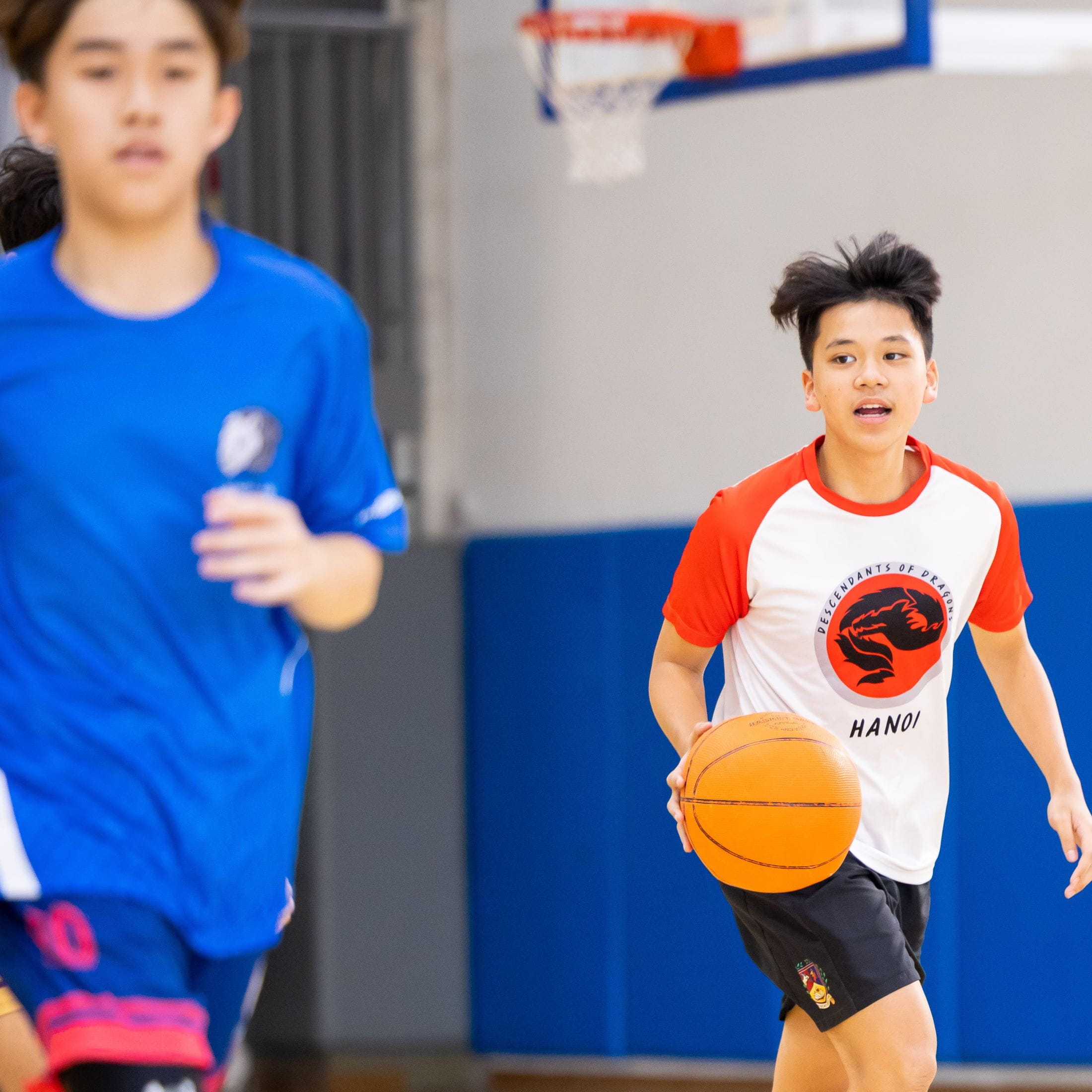 Secondary students playing basketball during a CCA