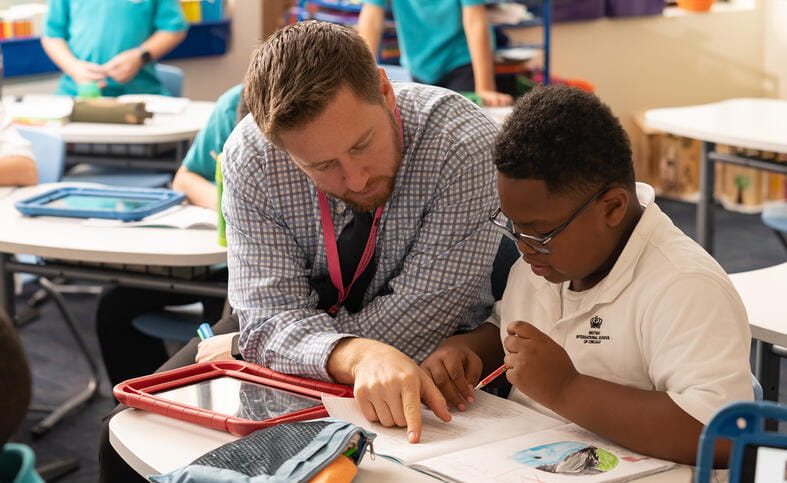 BISC South Loop teacher helping primary school student