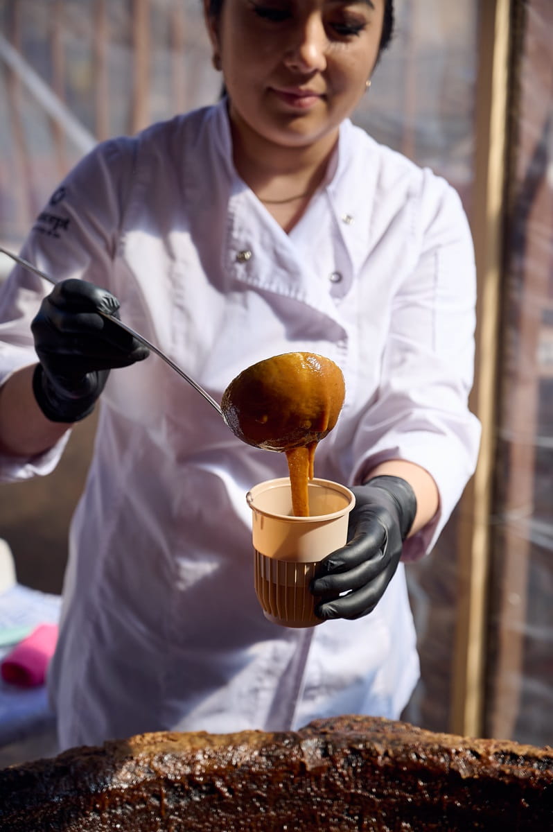 Uzbek woman serving sumalak
