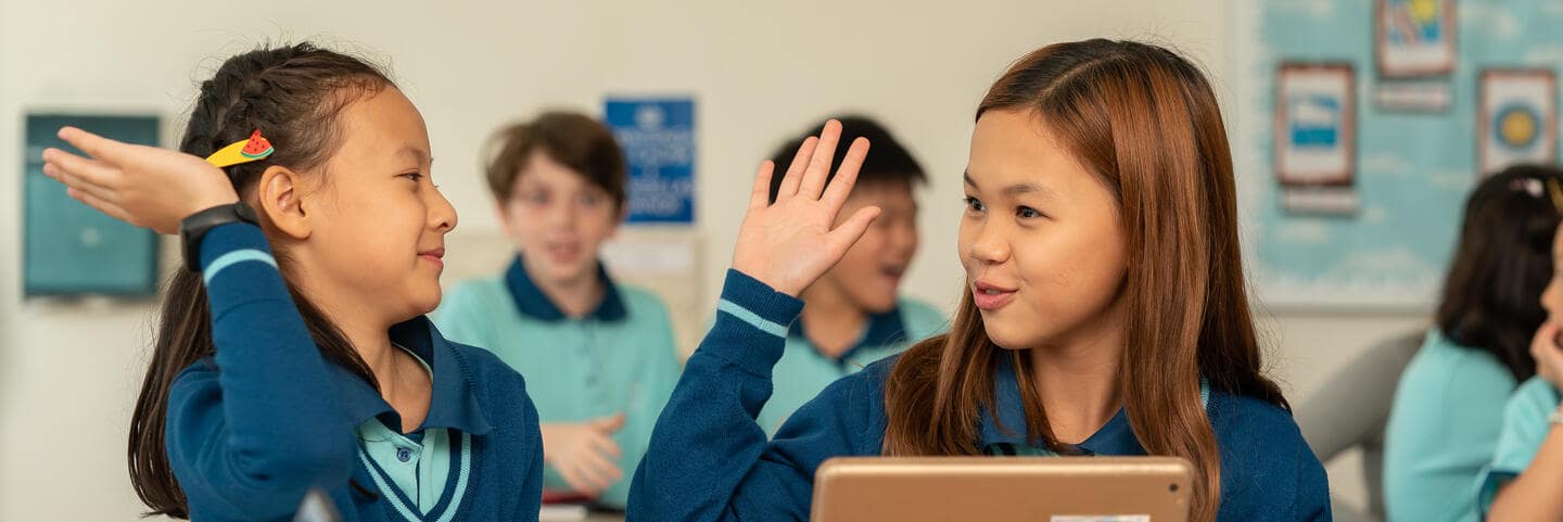 Two girls smiling with each other