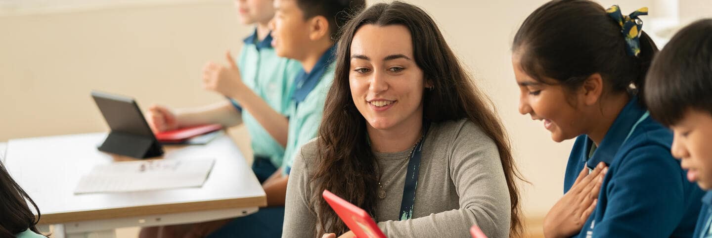 Teacher smiling with students