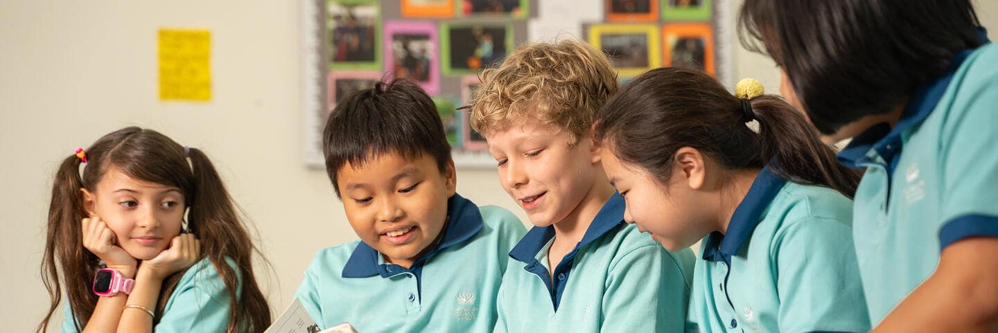 Students looking at a book together