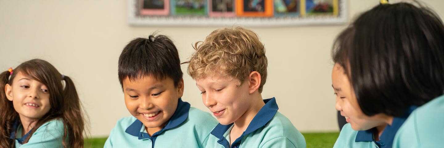 Students looking at a book together