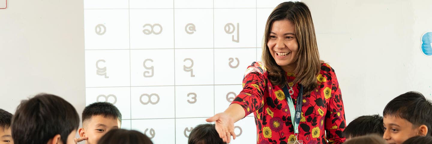 Teacher smiling a class