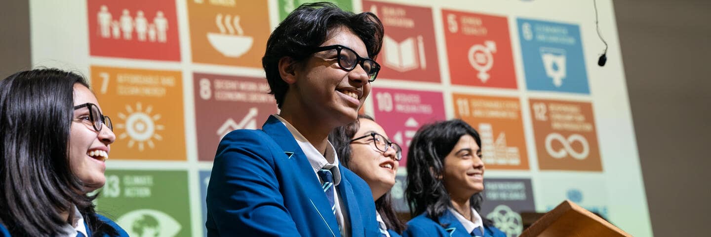 Students standing up in front of classmates