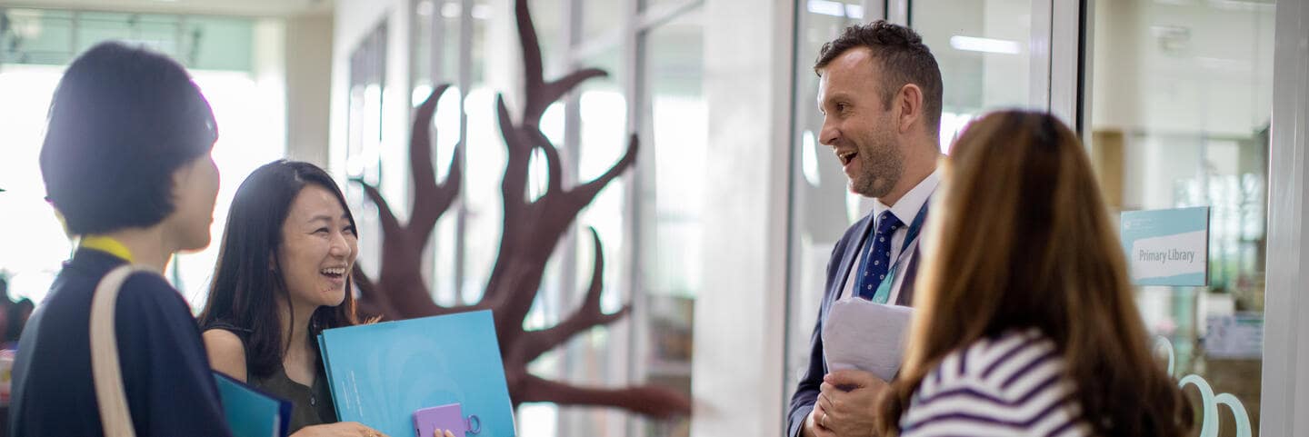 Teachers smiling with each other