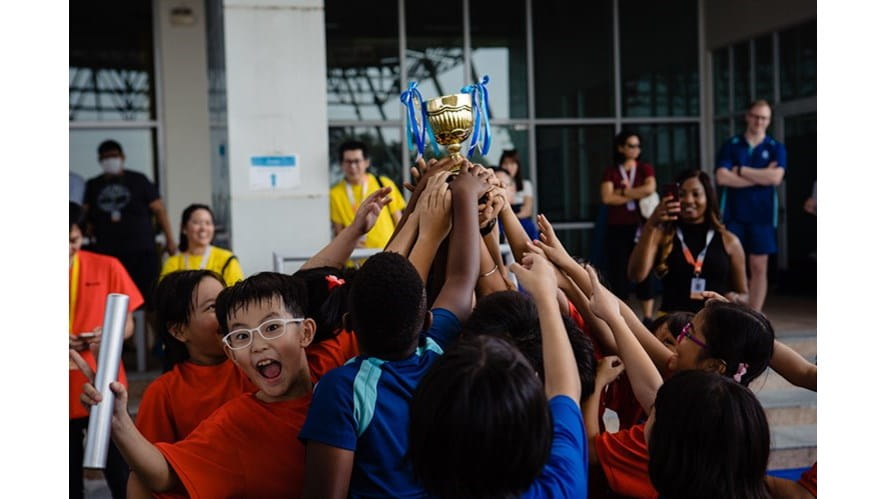 Kids holding up the cup