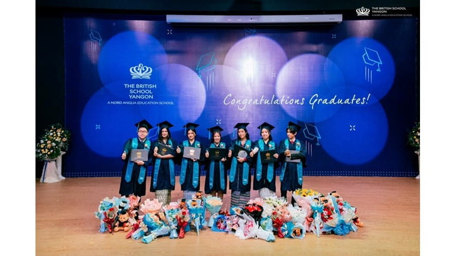 Students holding up their awards