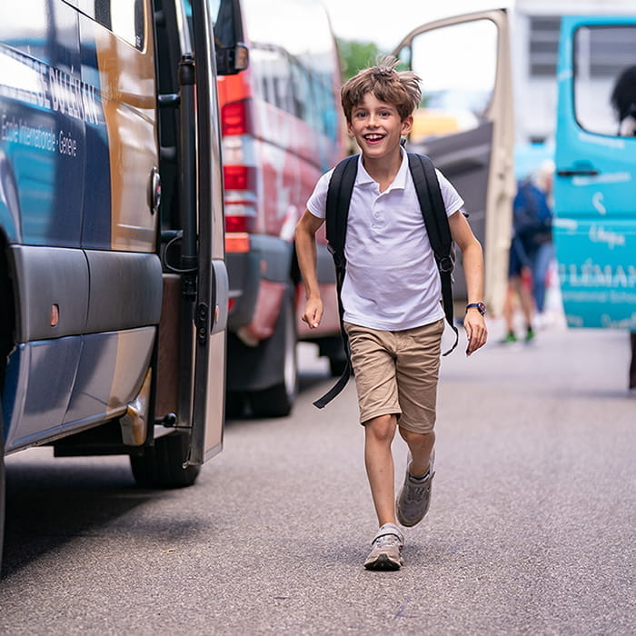 boy running happily towards camera at Collège du Léman in Geneva