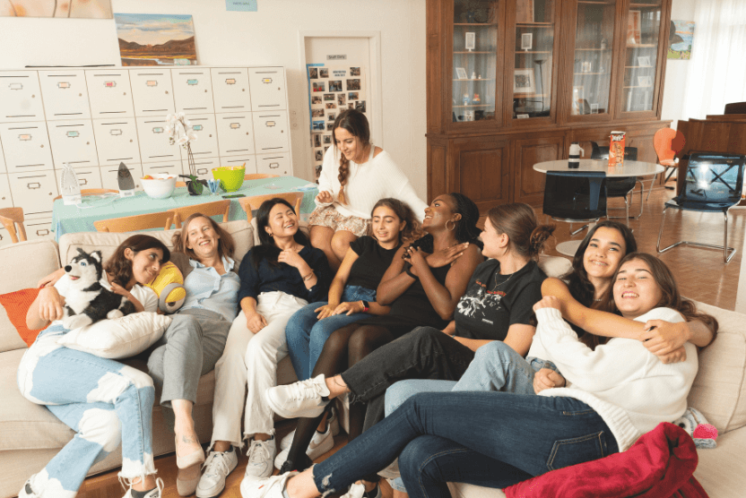 Boarding students laughing and bonding in their residence lounge, sharing friendship and everyday joy.