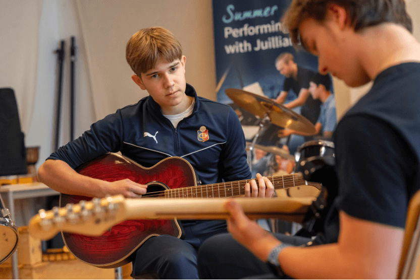 Boarding students collaborating during a music session, developing creativity and skill through the arts at CDL.