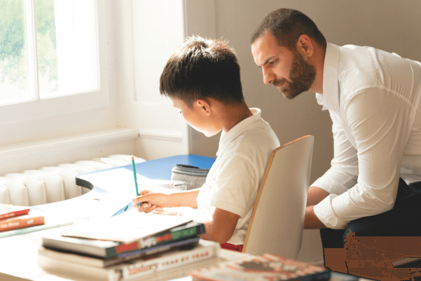 CDL House Parent providing one-on-one academic support to a younger student, emphasising personalised guidance.