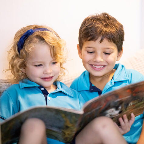 Two young childen reading toegther - EYFS curricula singapore