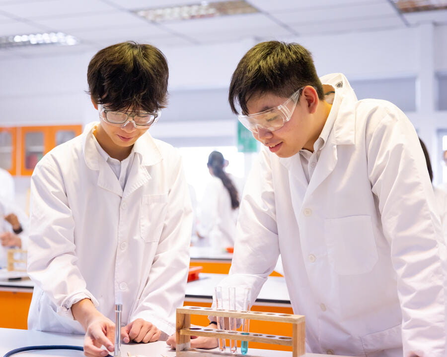 Two boys having a practical IGCSE science lesson at DCIS