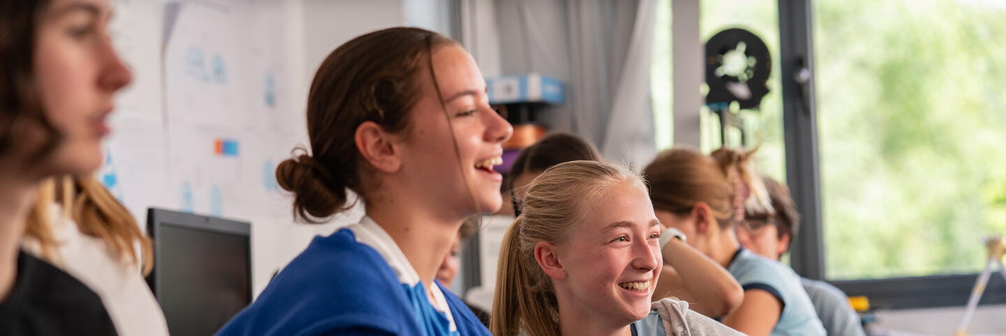 Schools with EAL Support in Madrid | ICS-Content Page Header-Girls laughing in class 