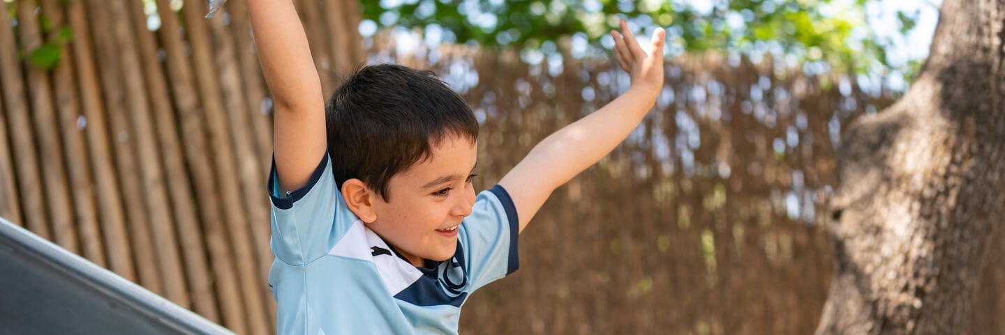 Boys smiling with hands up
