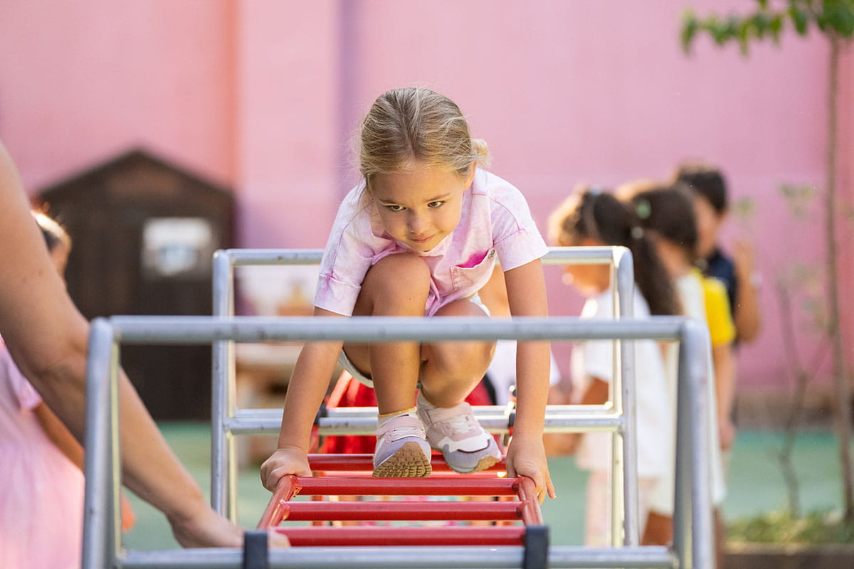 Young child developing confidence and self-regulation through outdoor play at ICS.