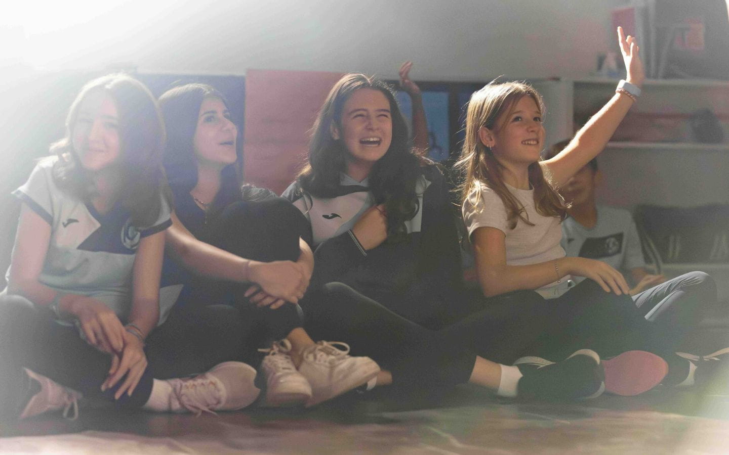 Girls sitting down smiling