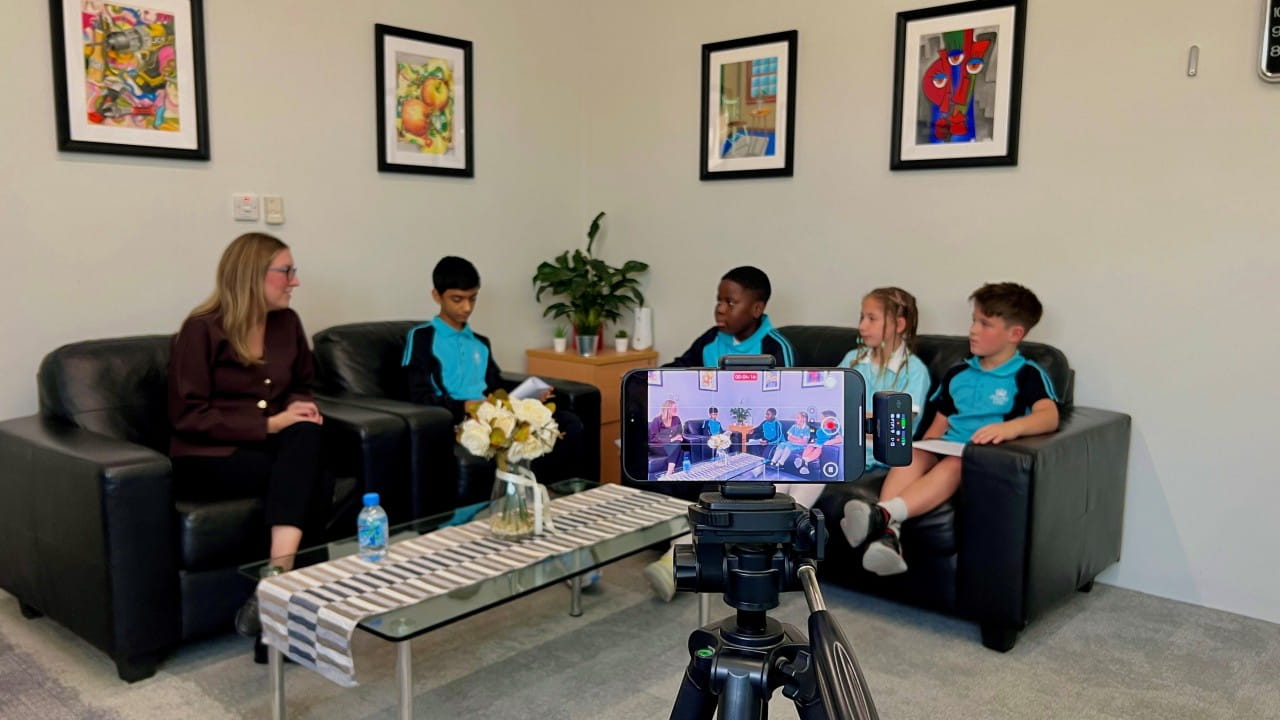 students and teacher on sofa