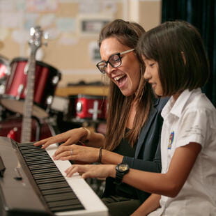 Young student learning piano with teacher - Nord Anglia Education
