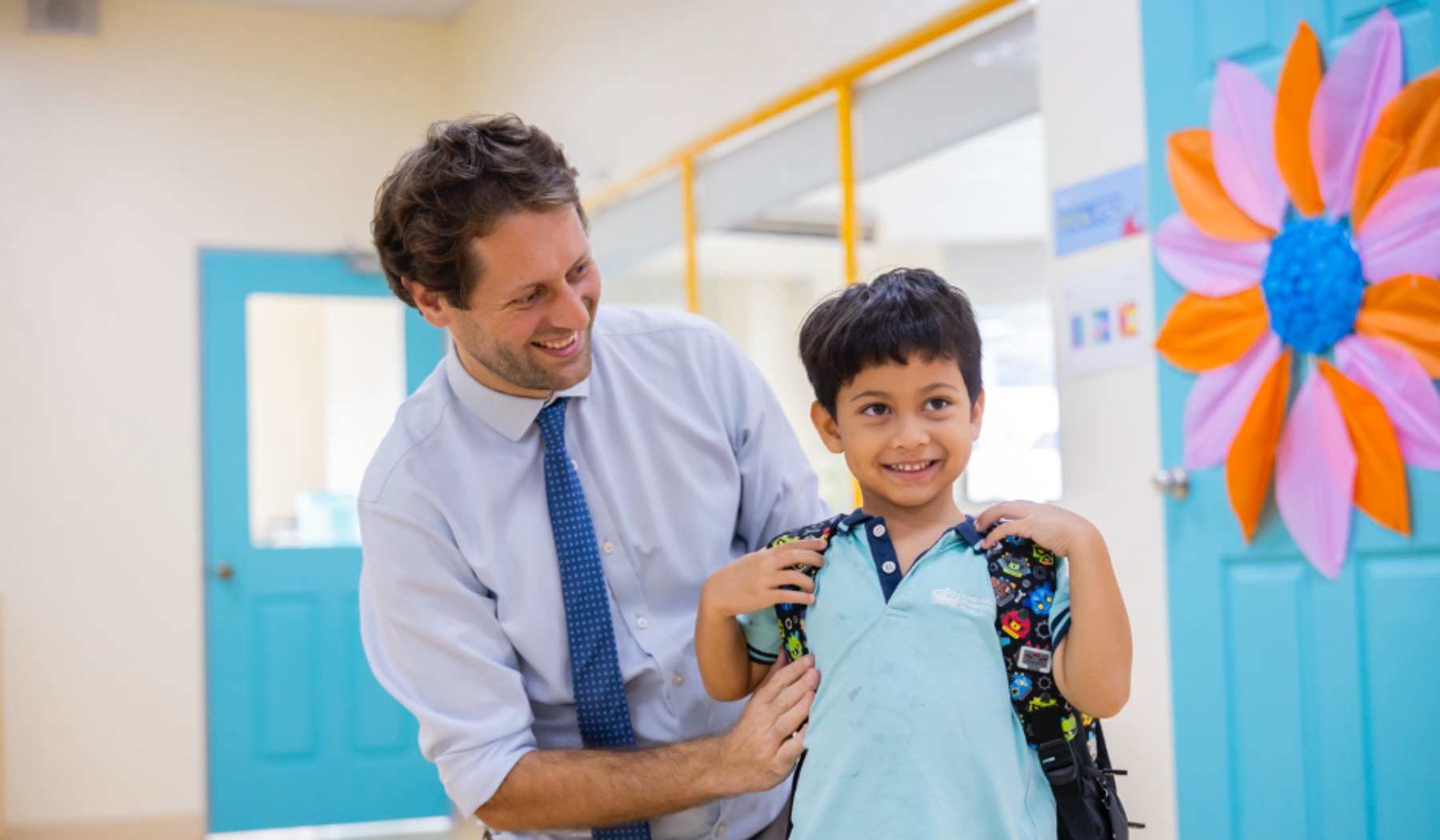 Father helping out his son to get ready for school