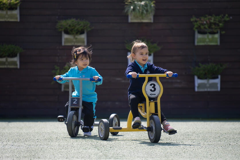 NAID Pudong early years students riding bikes