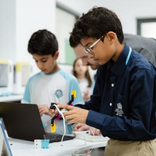 Students looking at laptop