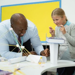 Teacher helping students