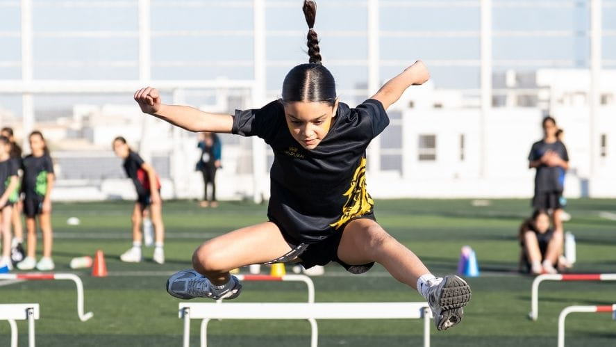 Student jumping during hurdles on sports day