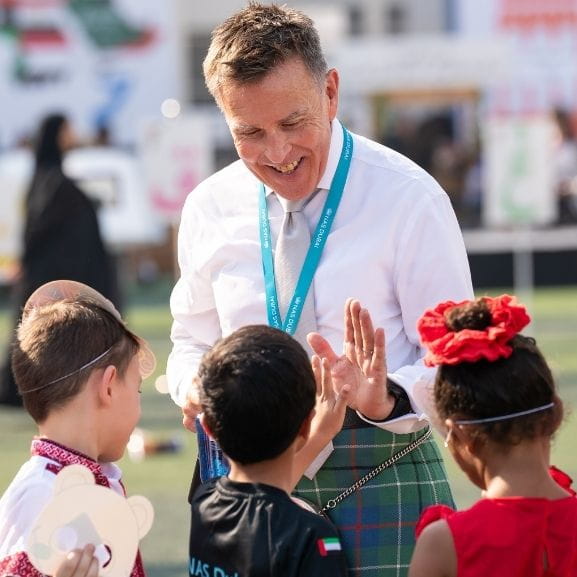 School Principal Engaging with Students at Cultural Celebration