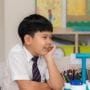 Primary school boy smiling in classroom learning environment