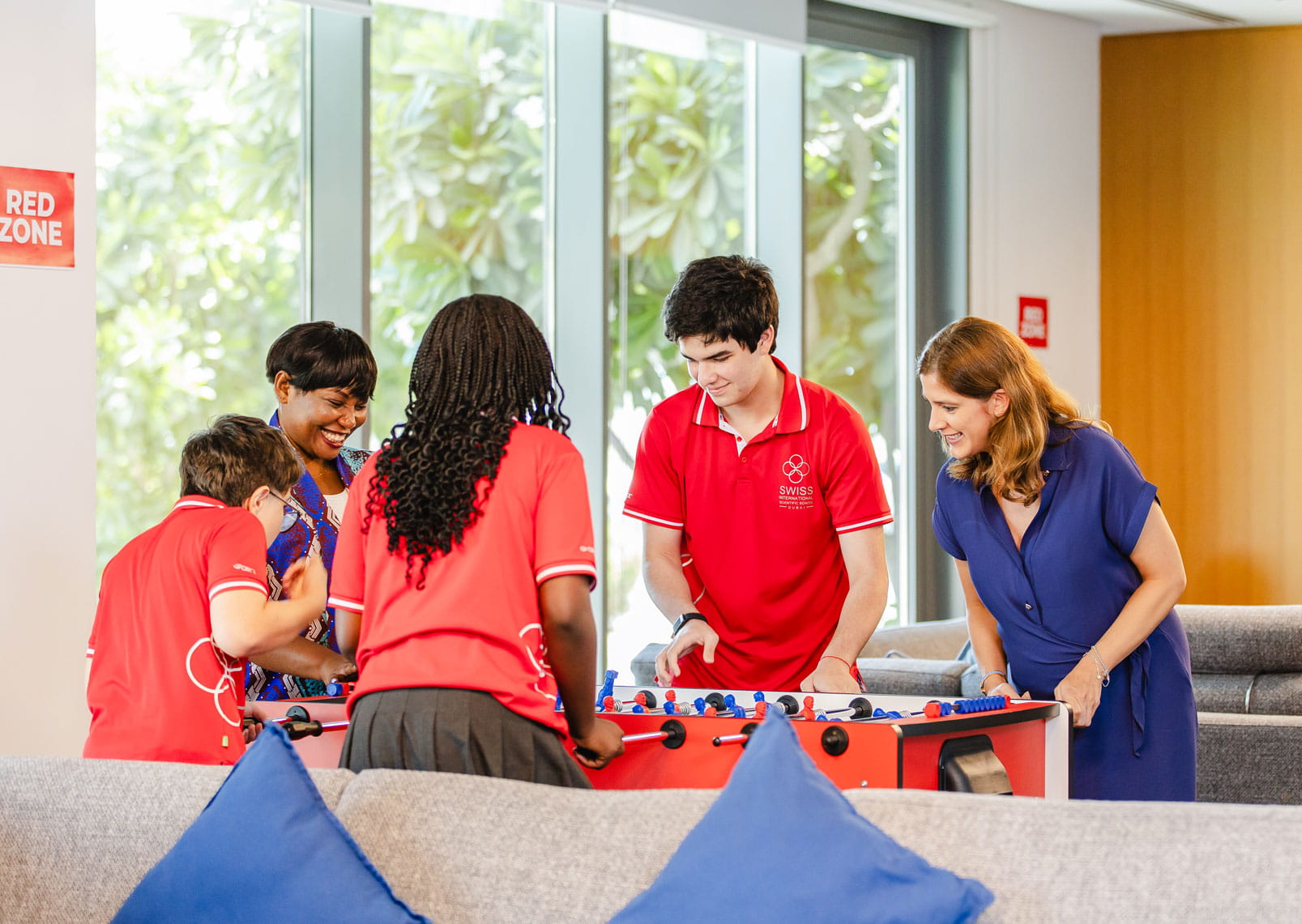 students and staff playing table football