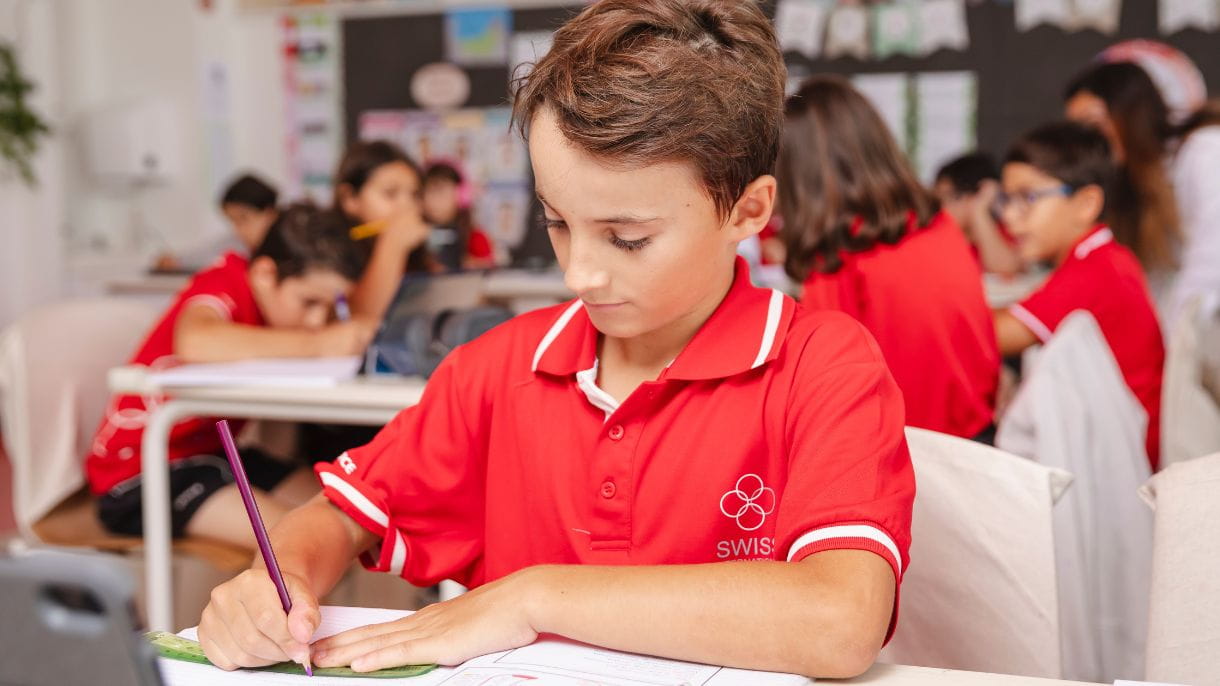 student writing at a desk