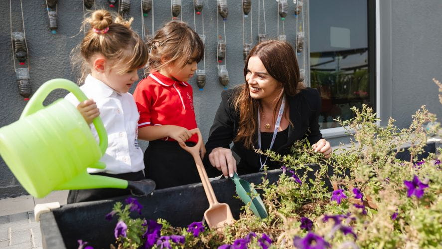 teacher and students in garden