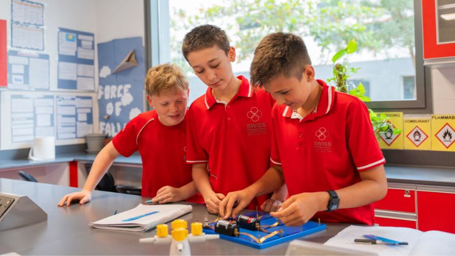 three students in science lab