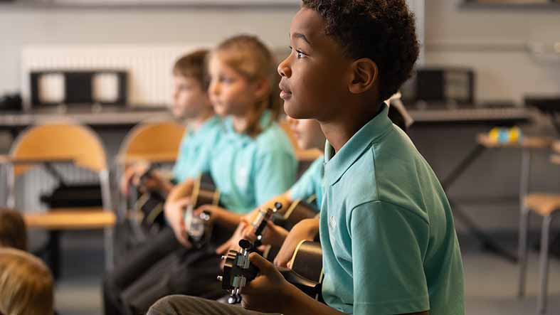 boy playing on guitar