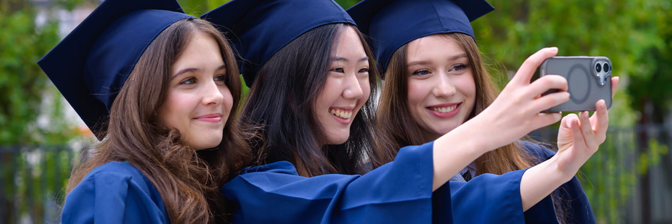 three secondary students taking a photo