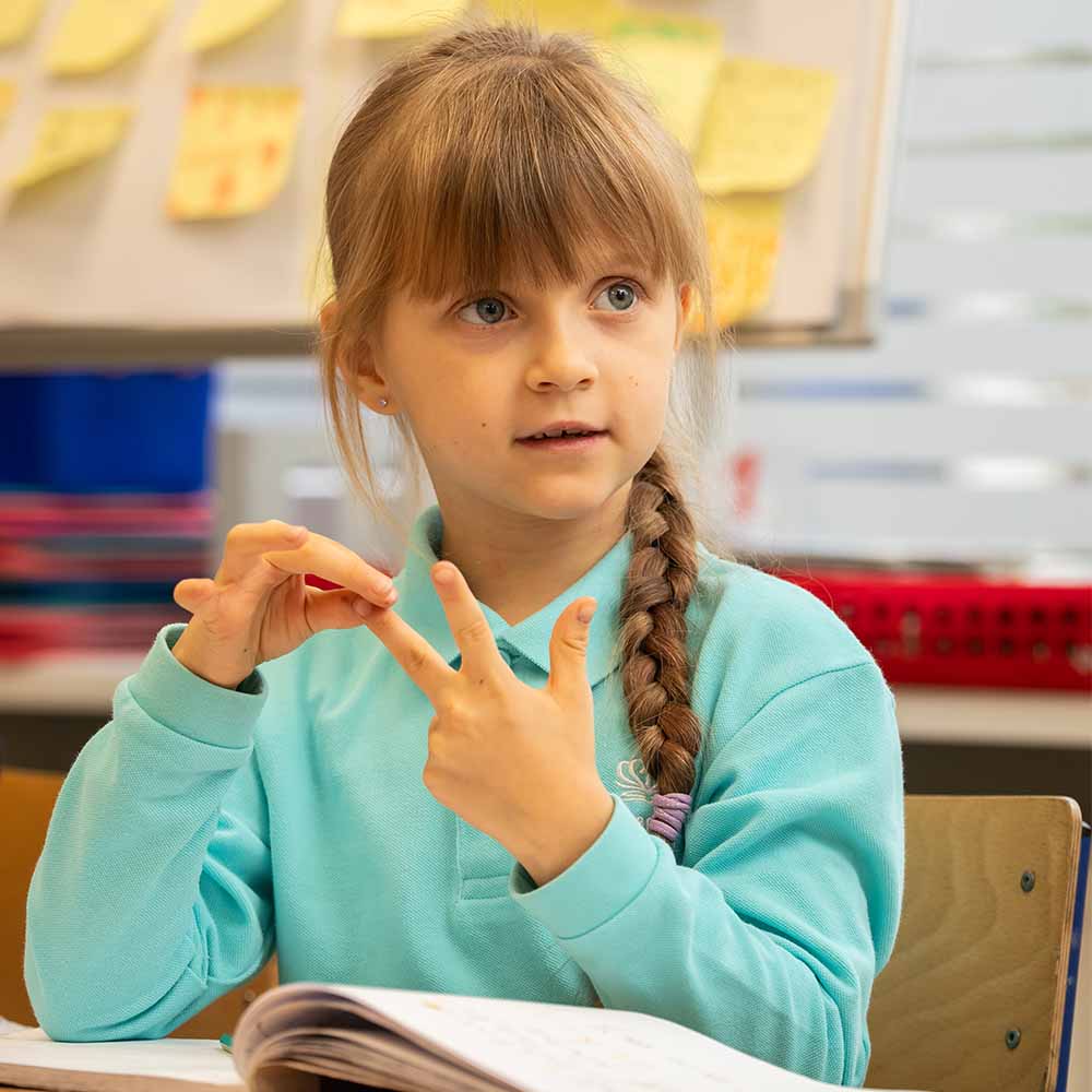 a student counting on her fingers