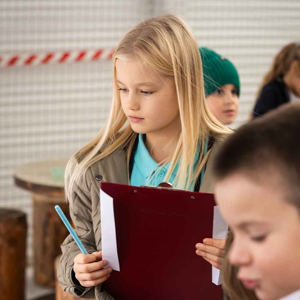 Primary student with a clipboard