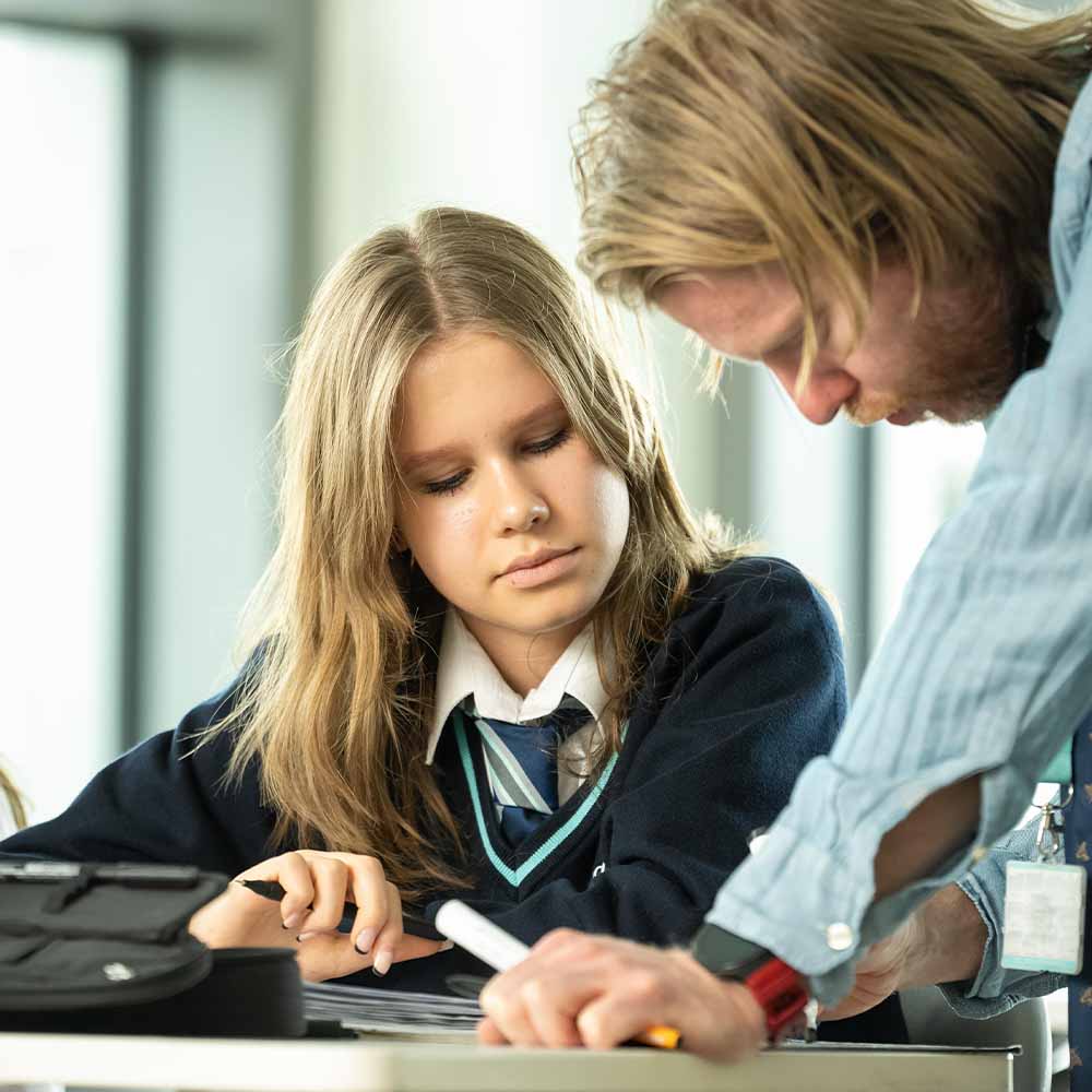 teacher explaining lesson to student